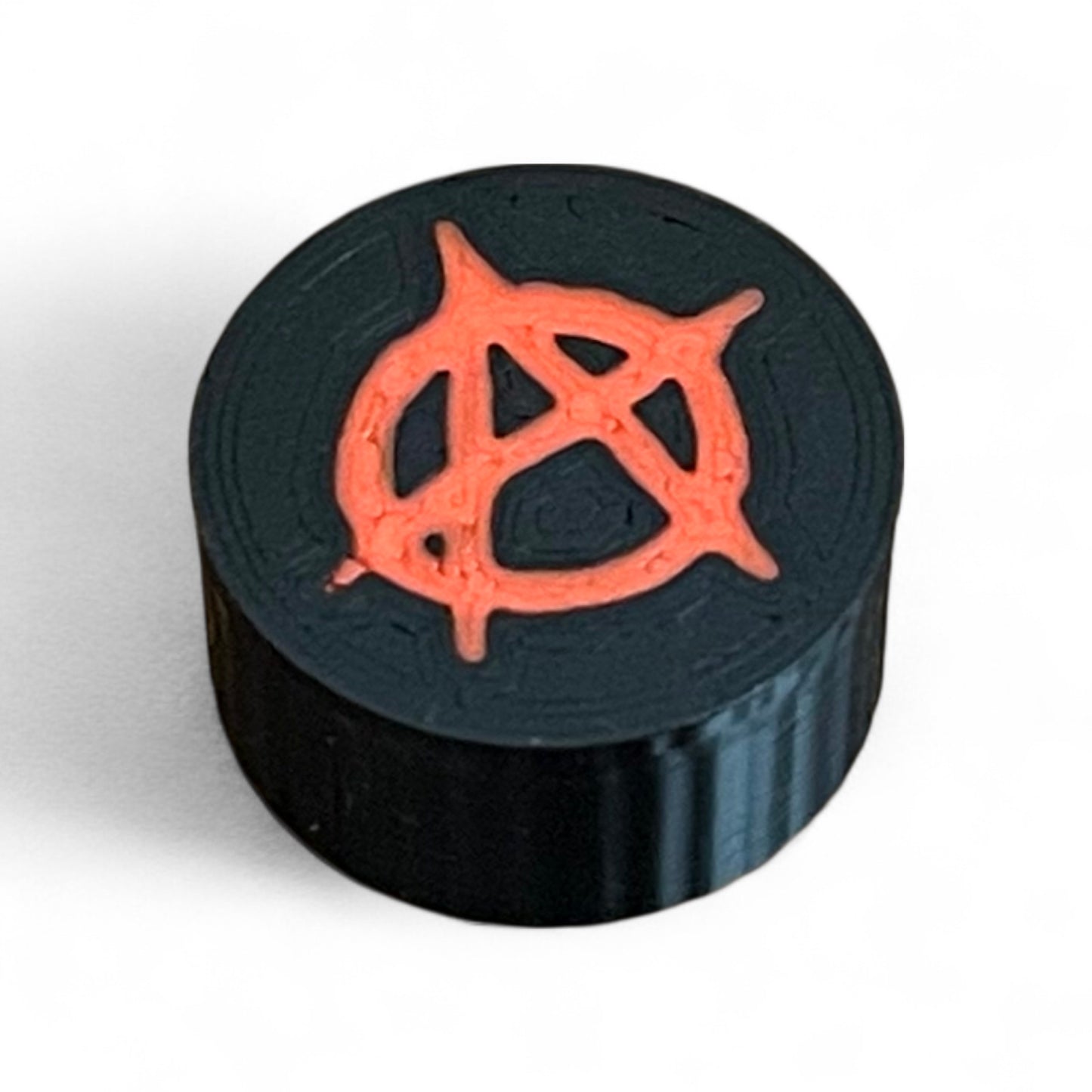 3D printed Anarchy Sign Guitar Pedal Footswitch Topper by Cold Earth Industries, shown in black with a red anarchy symbol on a white background.