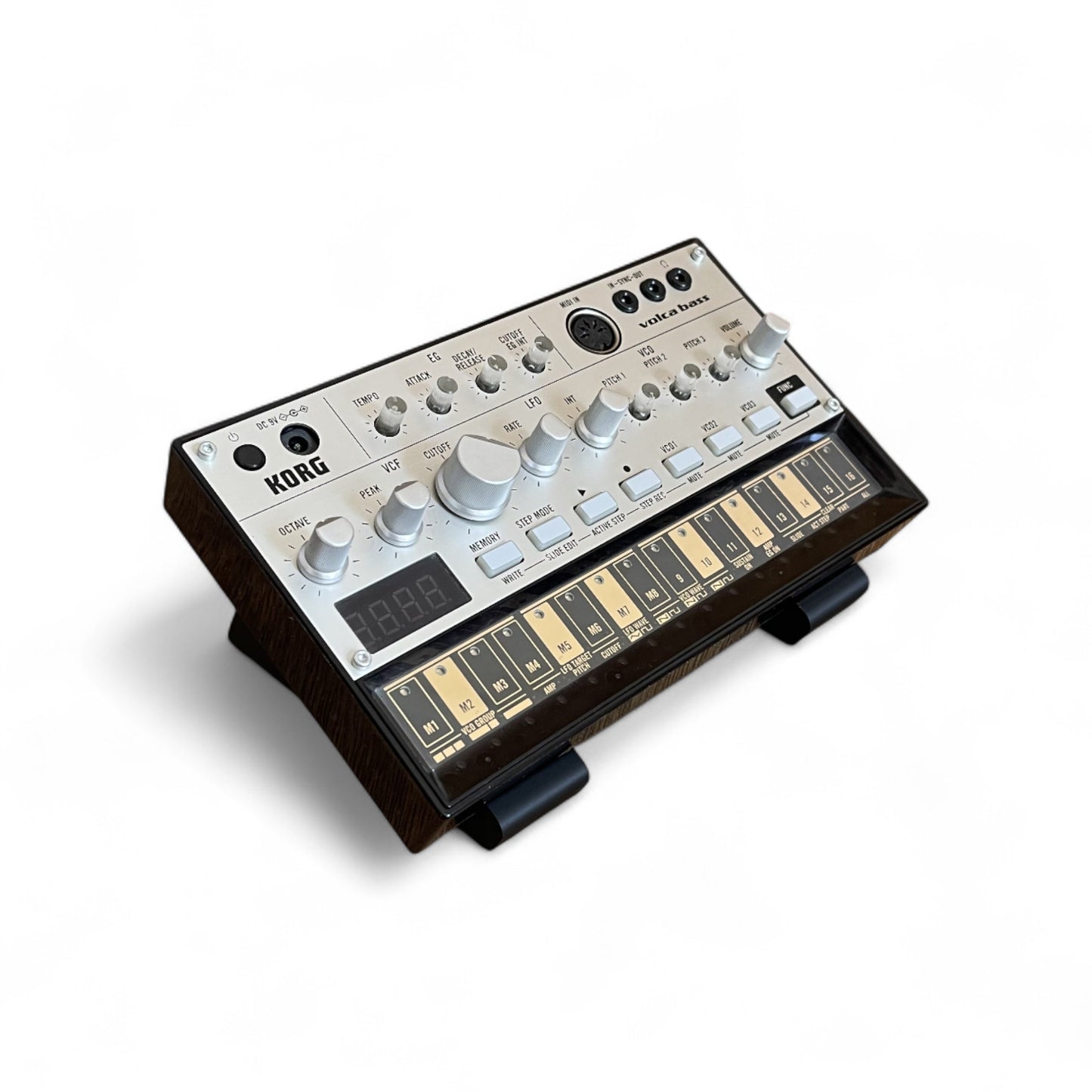 3D printed Cold Earth Industries Small Synth stand by Cold Earth Industries, 30 Degree angle, shown in black on a white background holding a Korg Volca Bass – custom desktop stands.