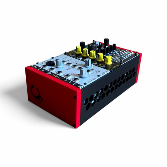 3D printed 42HP 3U Eurorack modular synthesizer case by Cold Earth Industries, shown with black body and red side panels filled with euroack modules on a white background – custom desktop skiff enclosure.