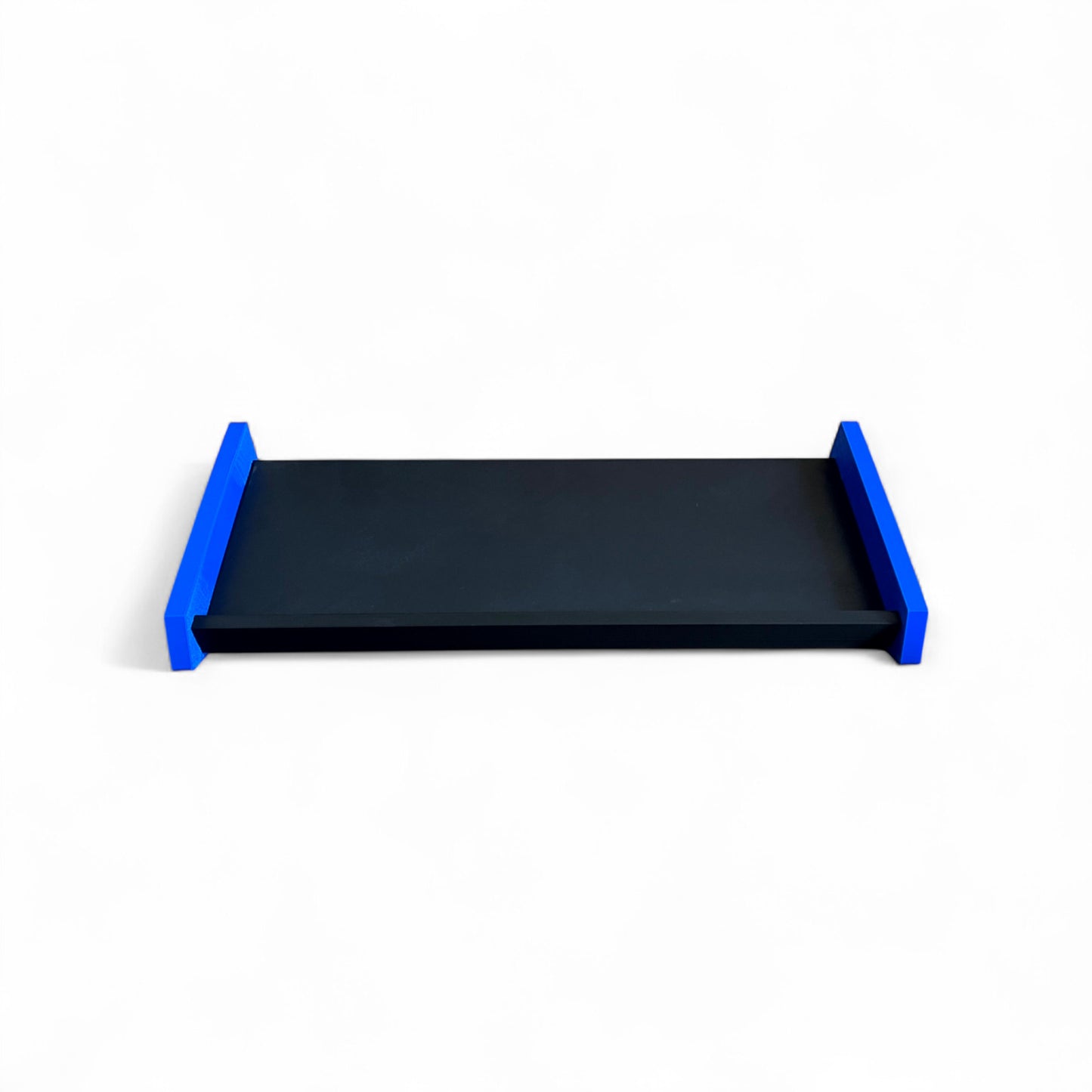 3D printed Desktop Pedalboard 400mm x 150mm 30 Degree Guitar Pedal & Synth Stand stand by Cold Earth Industries, shown from in front, in black with blue sides, on a white background – custom desktop stands.