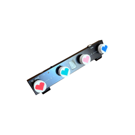 Guitar Pedal Footswitch Topper for 8.5mm / 10mm / 11mm Foot Switch. 3D printed Heart Design on White Toppers with a Green, Red, Pink and Blue heart by Cold Earth Industries, shown on a guitar pedal on a white background.