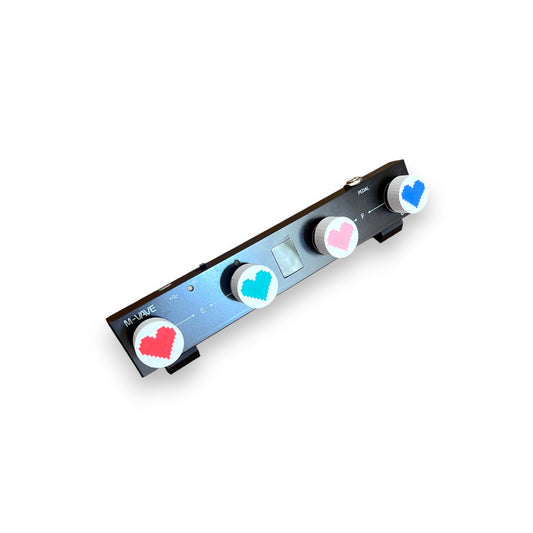 Guitar Pedal Footswitch Topper for 8.5mm / 10mm / 11mm Foot Switch. 3D printed Heart Design on White Toppers with a Green, Red, Pink and Blue heart by Cold Earth Industries, shown on a guitar pedal on a white background.