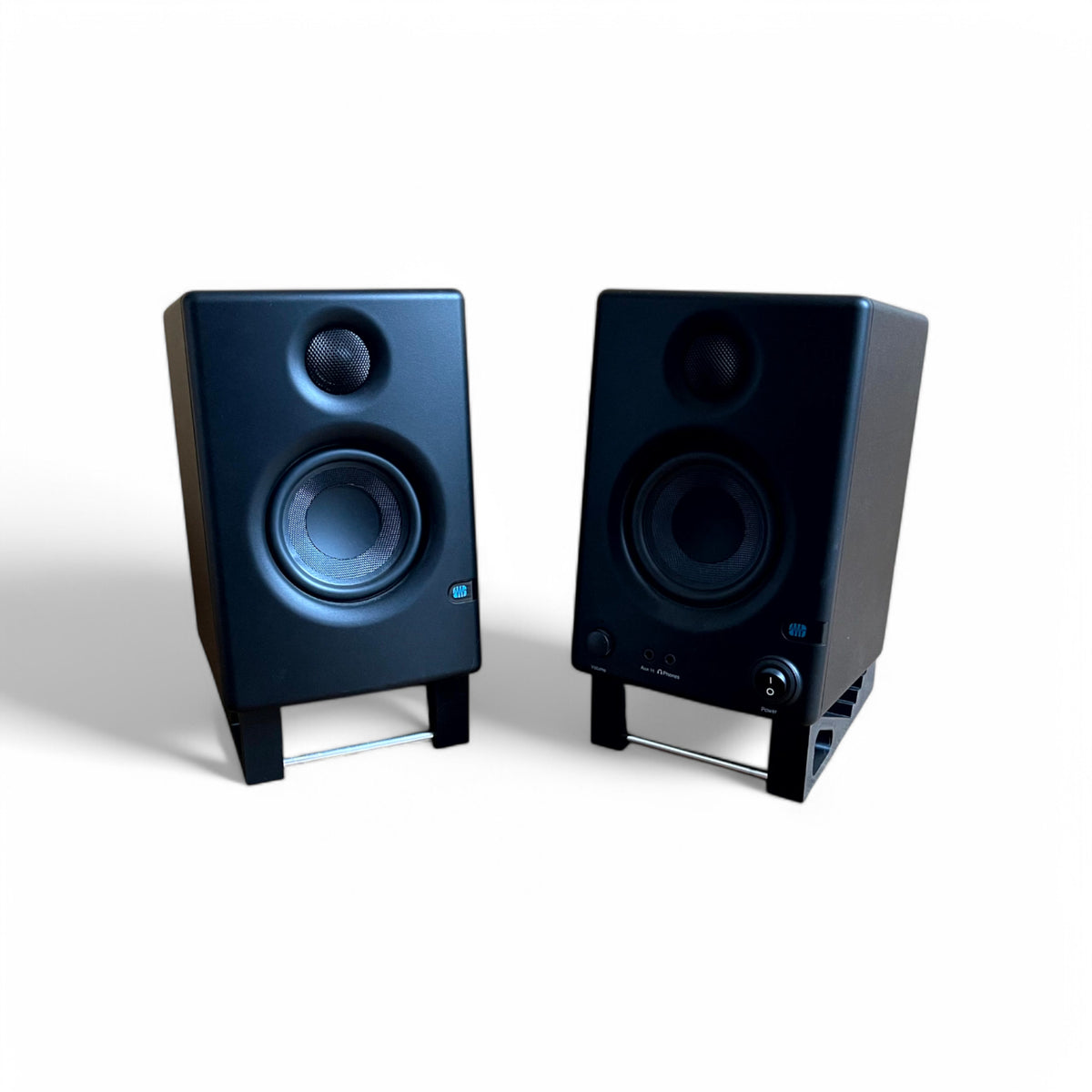 A pair of 3D printed Presonus Eris E3.5 Studio Speaker / Monitor 0 - 24 degree stands holding a pair of Presonus Eris 3.5 speakers, by Cold Earth Industries. Shown in white on a white background