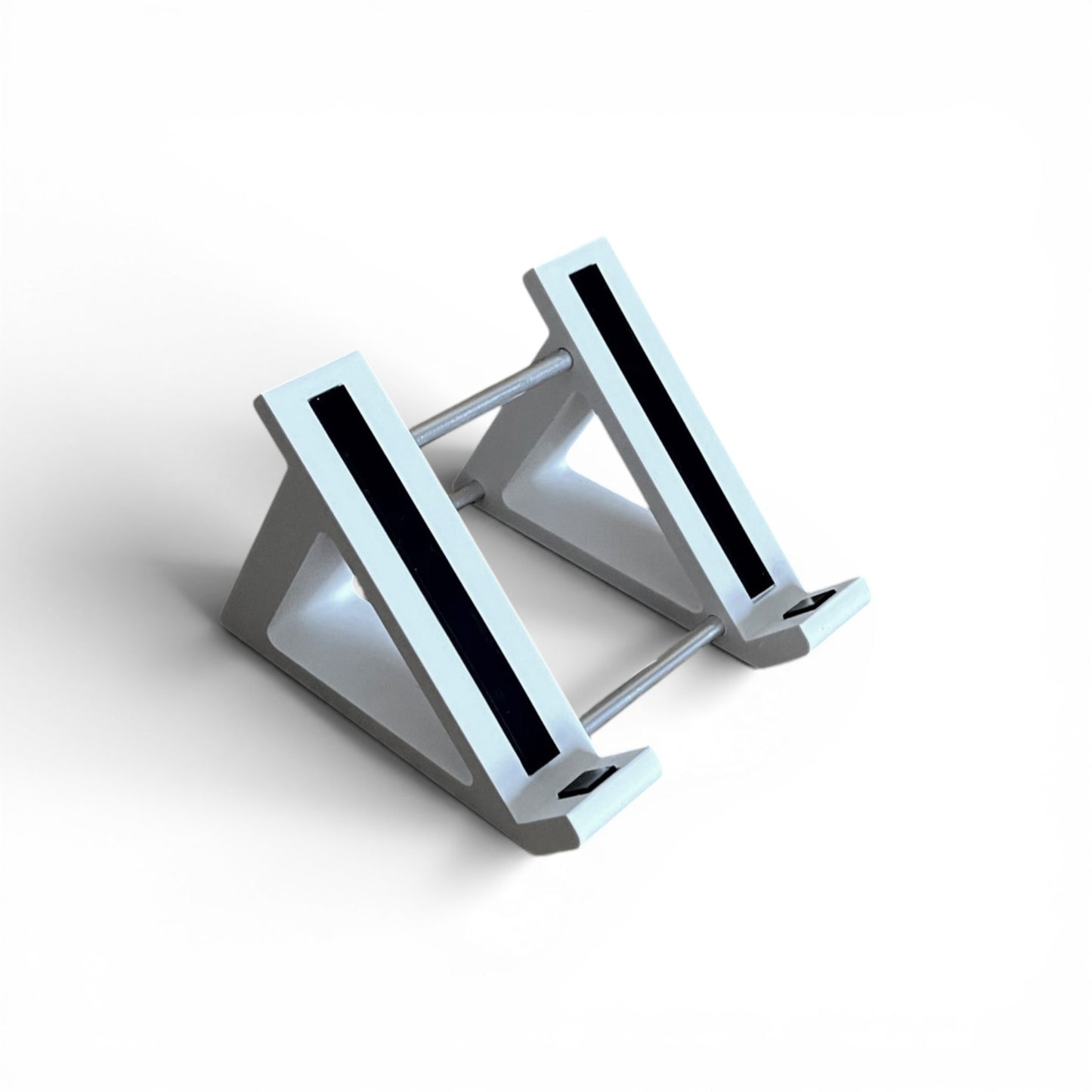 A 3D printed 45 degree white guitar pedal stand with rubber strips and recessed rubber feet, designed for the Line 6 HX Stomp Amp and Effects Processor.