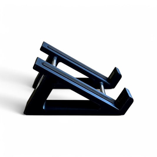 A 3D printed 30 degree black guitar pedal stand shown in side view, with rubber strips and recessed rubber feet, designed for the Line 6 HX Stomp Amp and Effects Processor.