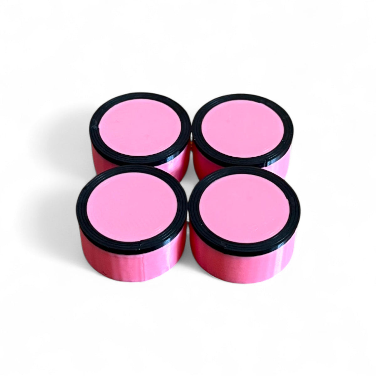 Set of 4 Guitar Pedal Footswitch Topper for 11MM Foot Switch. 3D printed Pink Base and Black Ring Design by Cold Earth Industries, shown on a white background.
