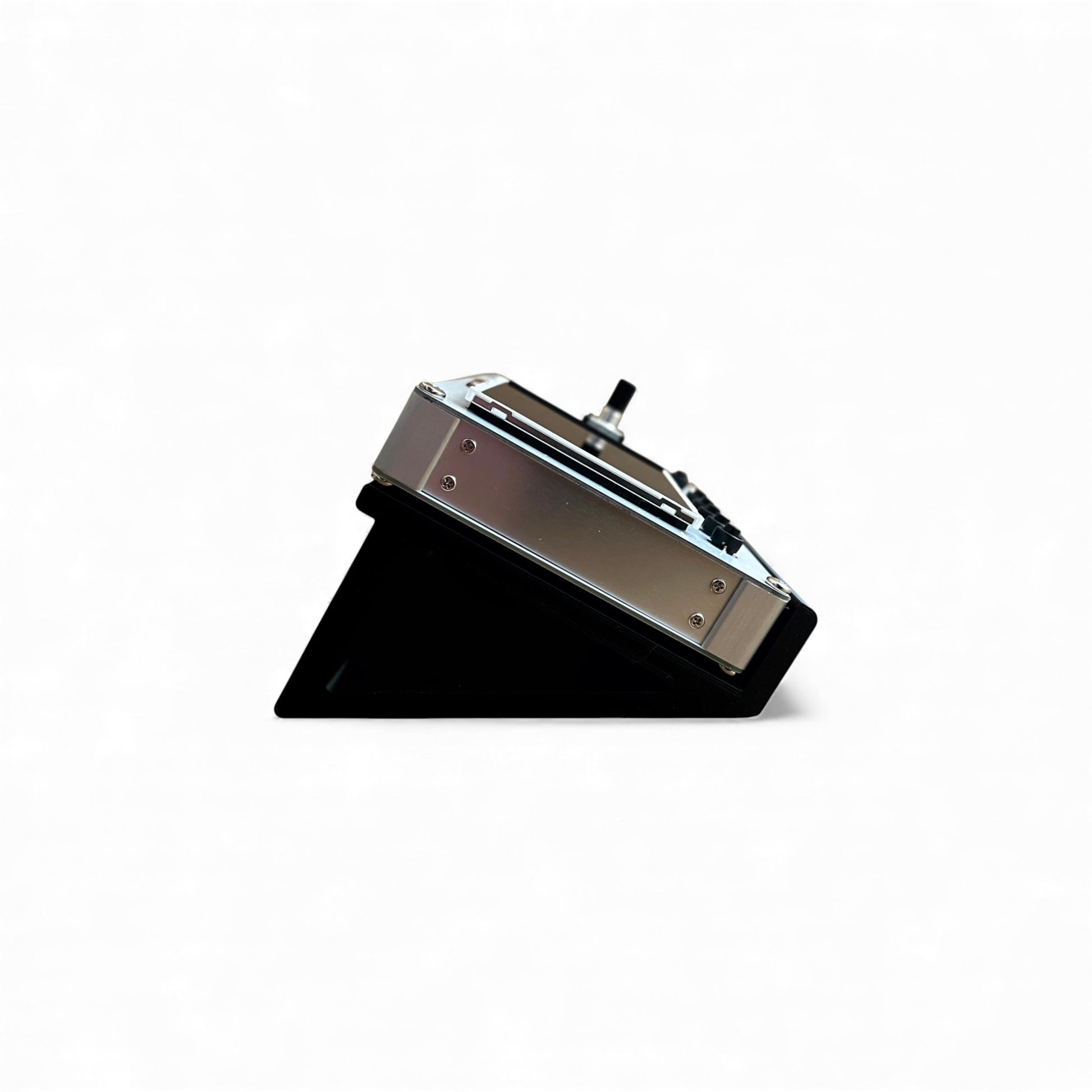 3D printed Korg Nu:Tekt NTS-2 Oscilloscope 30 degree stand by Cold Earth Industries, shown side view in black on a white background holding a Korg Nu:Tekt NTS-2