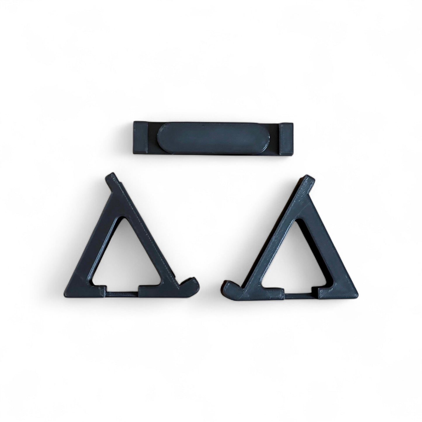 3D printed Korg Nu:Tekt NTS-2 Oscilloscope FX 60 degree stand by Cold Earth Industries, shown in seperate parts in black on a white background