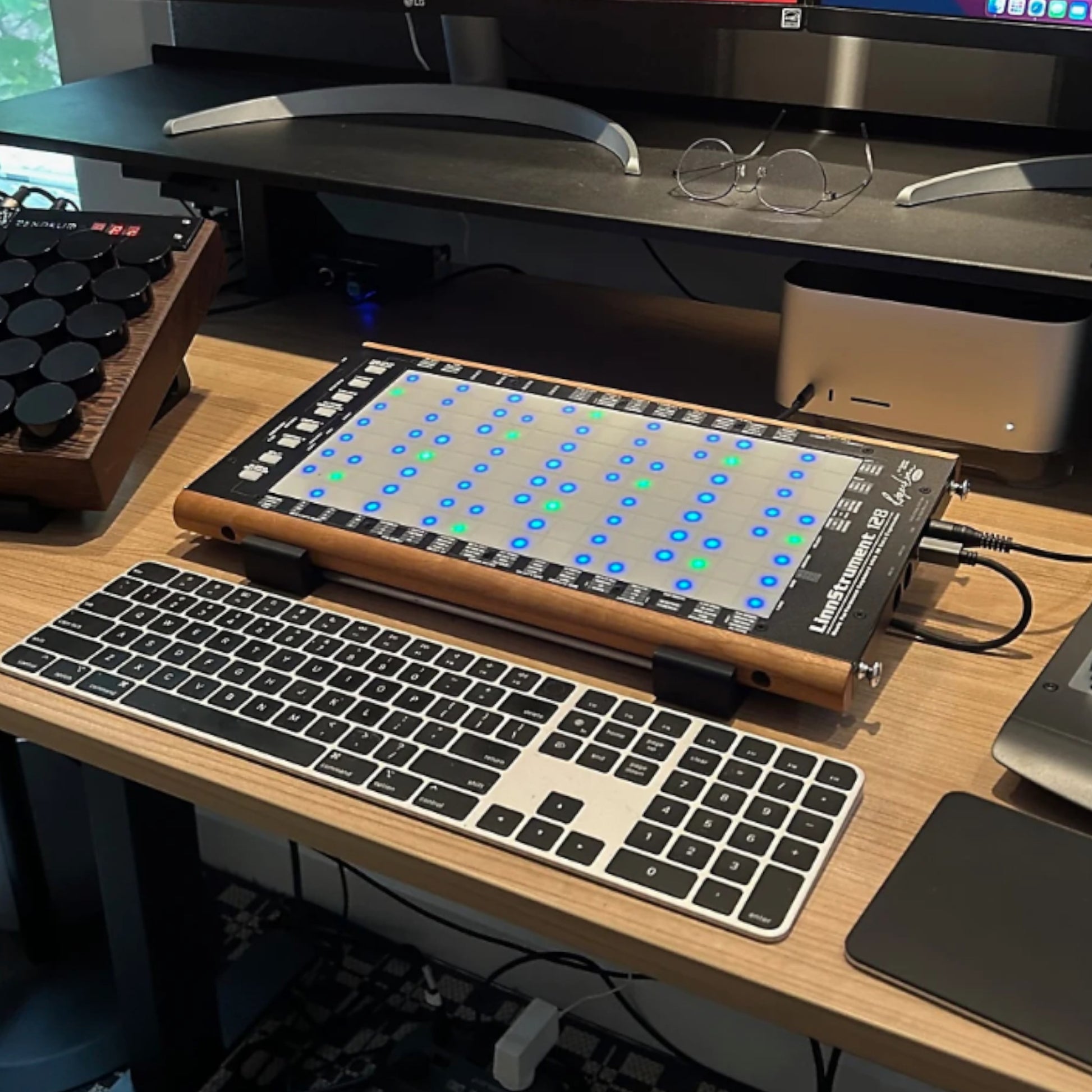 3D printed Robert Linn Design Linnstrument 128 Midi Controller 10 degree stand by Cold Earth Industries, shown in black holding a Linnstrument 128 in a recording studio