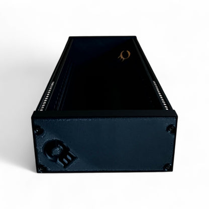 3D printed 62HP 3U Eurorack modular synthesizer case by Cold Earth Industries, shown with black body and black side panels, elevated side view, on a white background – custom desktop skiff enclosure.