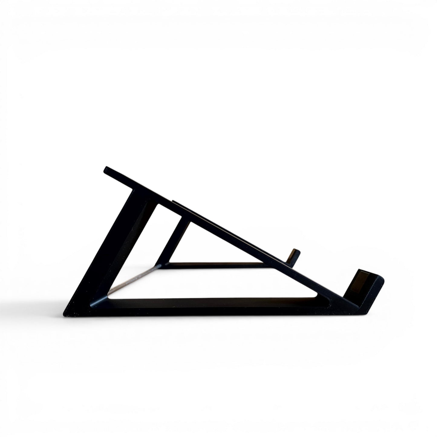 3D printed Akai MPC Live II Standalone Music Production Center 30 degree desktop stand by Cold Earth Industries, shown side view, in black, on a white background
