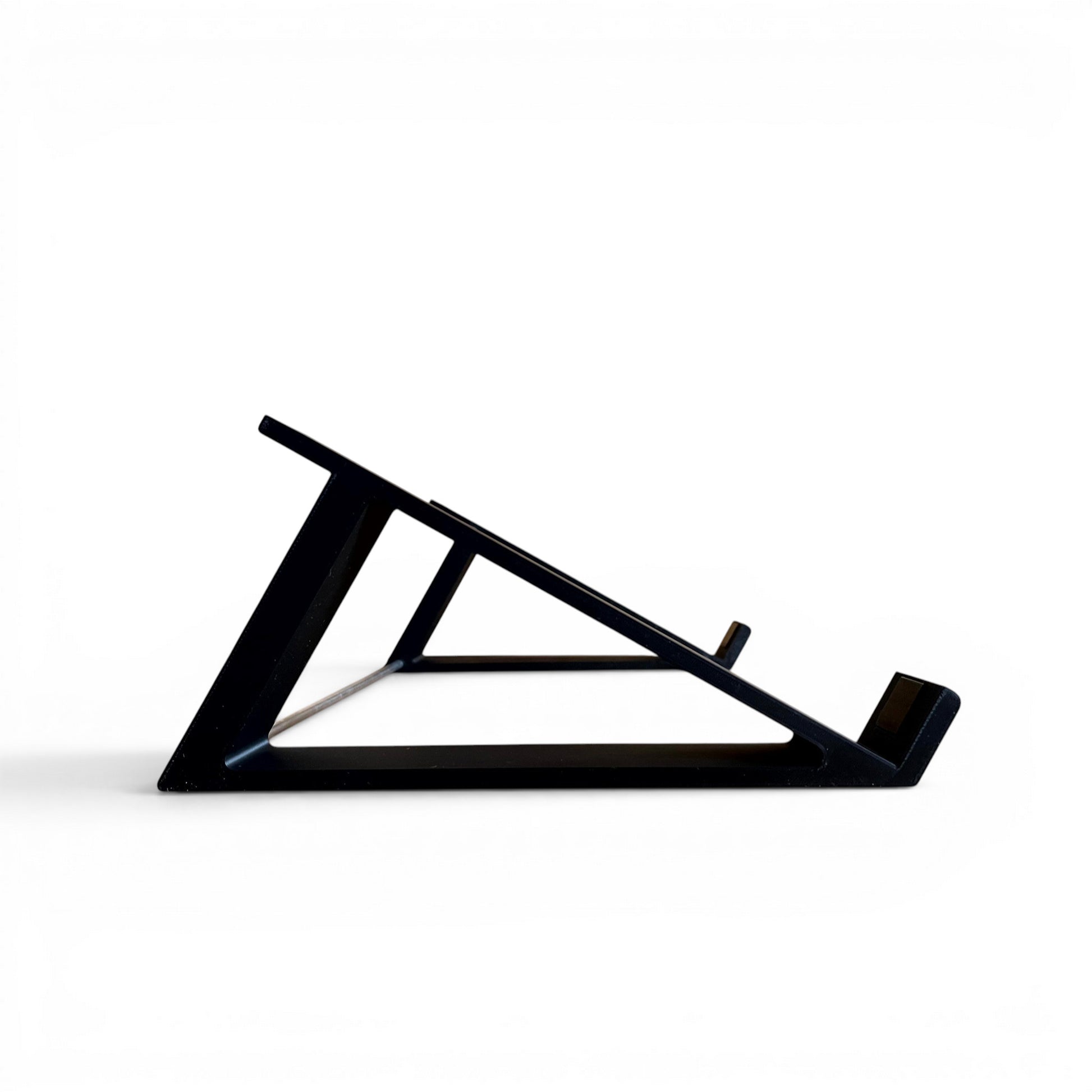 3D printed Akai MPC Live II Standalone Music Production Center 30 degree desktop stand by Cold Earth Industries, shown side view, in black, on a white background