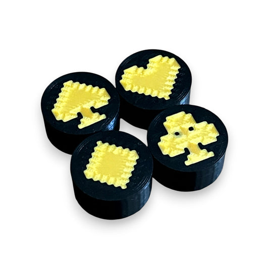 Set of 4 Black and Gold Card Suit Guitar Pedal Footswitch Toppers for 8.5mm / 10mm / 11mm Foot Switches. 3D printed by Cold Earth Industries, shown on a white background.