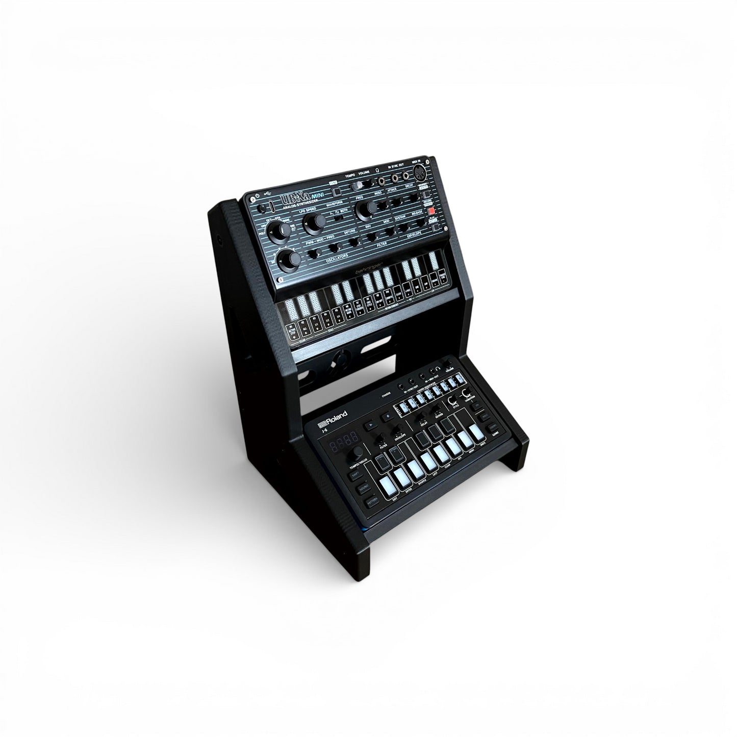 3D printed 2-Tier Korg Volca Roland Aira Behringer Mini | 30 / 60 Degrees | 195mm Width stand by Cold Earth Industries, shown holding Behringer Mini and Roland Aira, in black on a white background – custom desktop stands.