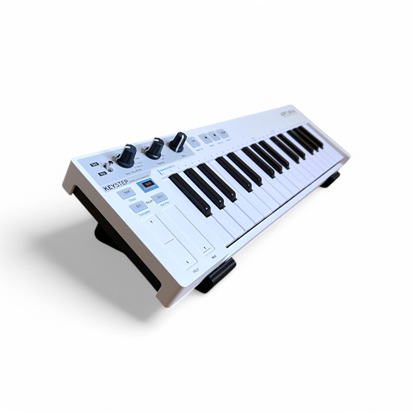3D printed Arturia Keystep Midi Keyboard 20 degree stand by Cold Earth Industries, shown in black on a white background holding Arturia Keystep