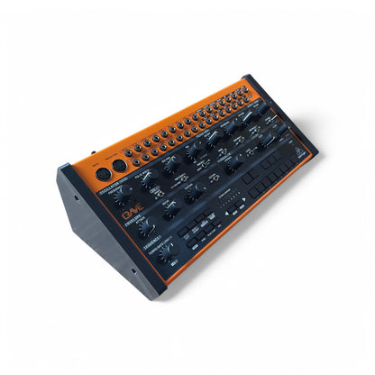 3D printed Behringer Crave / Edge / Spice / Grind Solid Side Panels Synth stand by Cold Earth Industries, shown with Behringer Crave reverse angle in black on a white background – custom desktop stands.