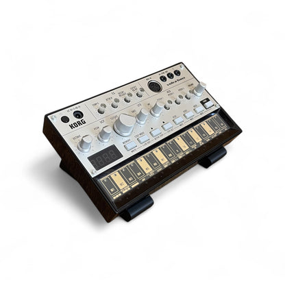 3D printed Cold Earth Industries Small Synth stand by Cold Earth Industries, 30 Degree angle, shown in black on a white background holding a Korg Volca Bass – custom desktop stands.