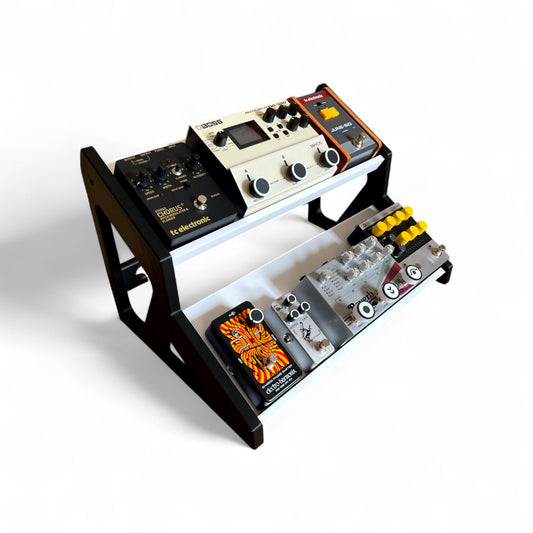 3D printed Guitar Pedal Desktop Stand 2 Tier 400mm width x 150mm hold depth per tier, 30 Degree Pedalboard & Synth Stand stand by Cold Earth Industries, shown in white with black sides on a white background shown holding guitar pedals – custom desktop stands.