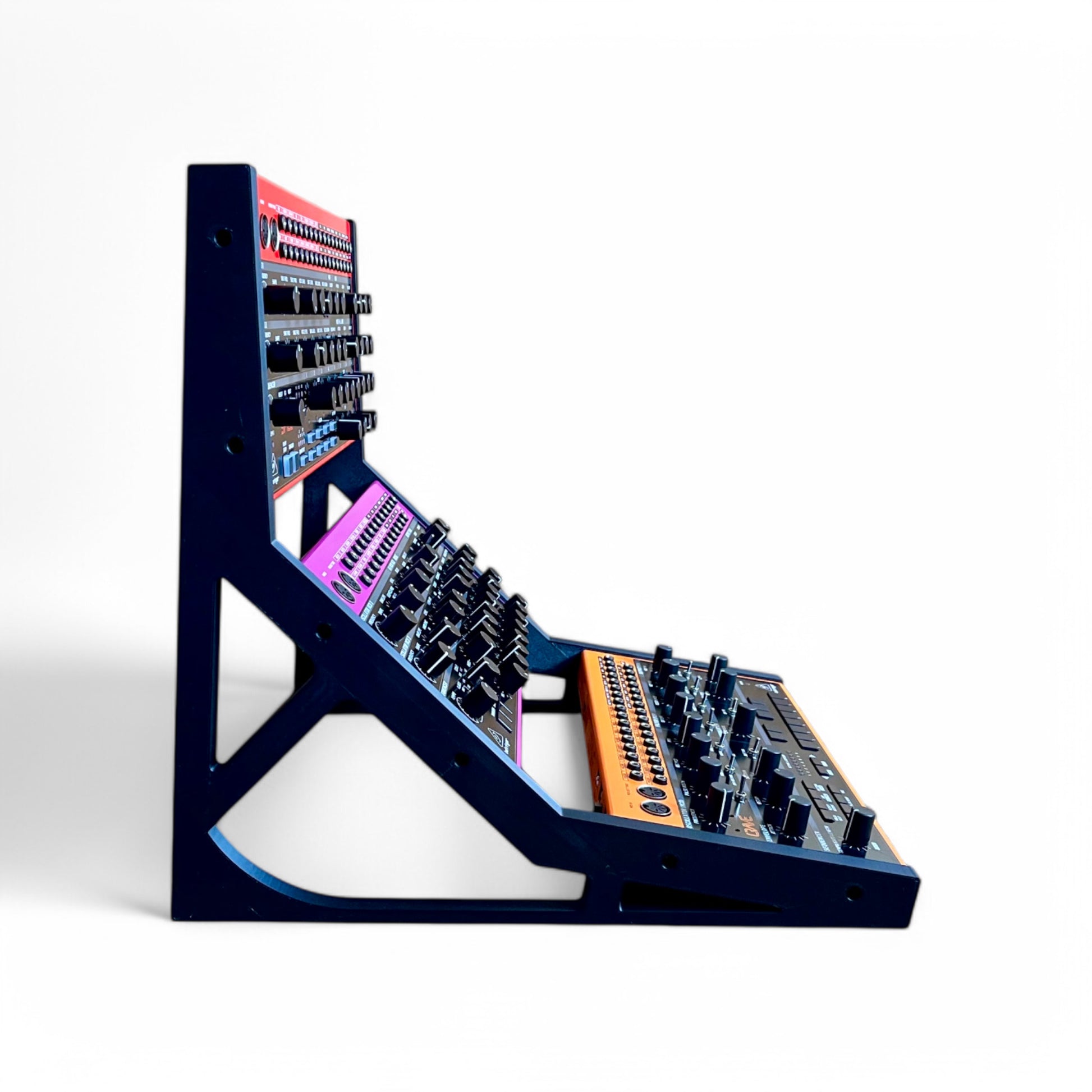 3D printed Behringer Crave / Edge / Spice / Grind 3 Tier Side Panels Synth stand by Cold Earth Industries, shown side view in black on a white background holding Behringer Crave, behringer Edge, Behringer Spice – custom desktop stands.
