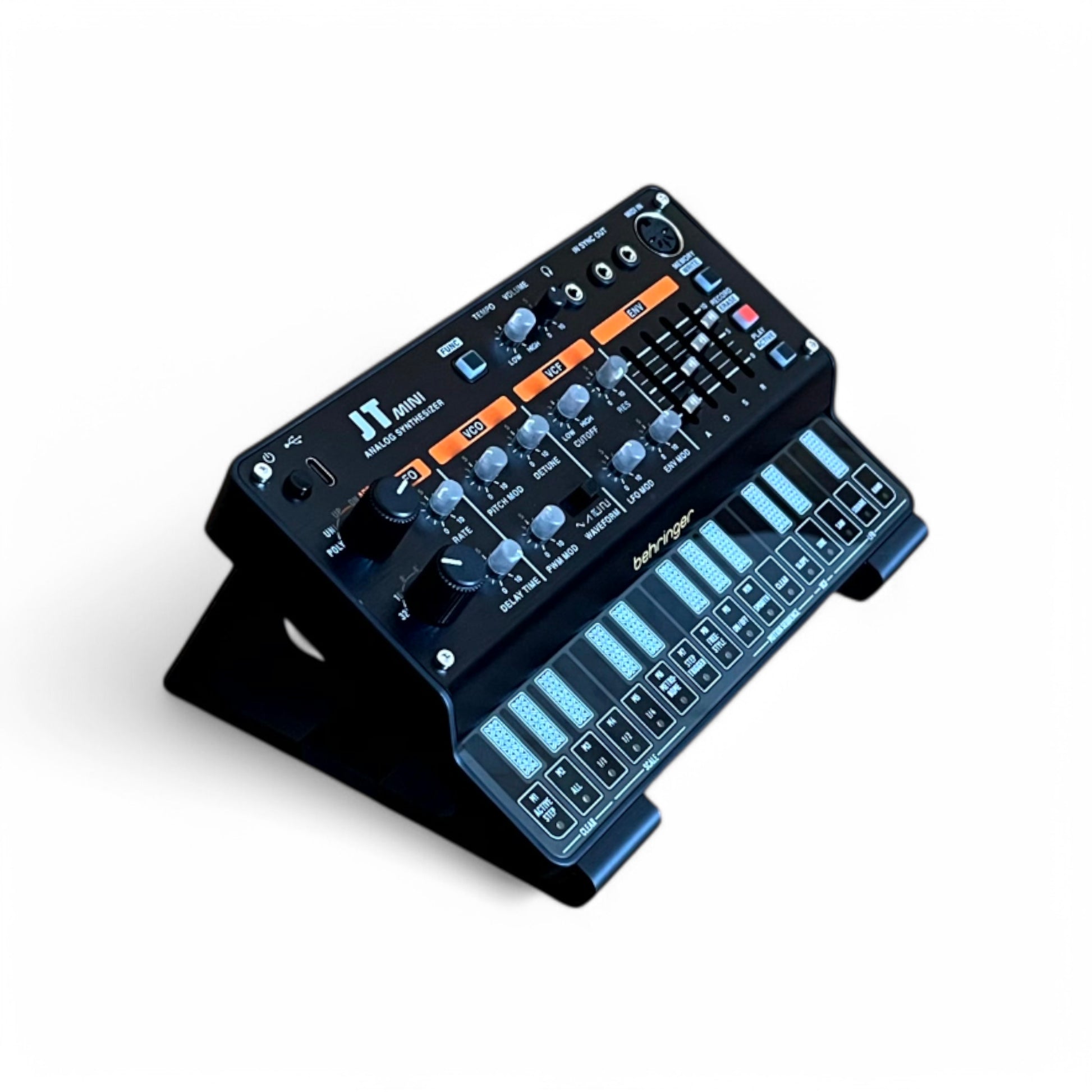 3D printed Behringer Pro VS Mini JT PHARA-O Synth 30 degree stand by Cold Earth Industries, shown in black on a white background with JT Mini (not included) – custom desktop stands.
