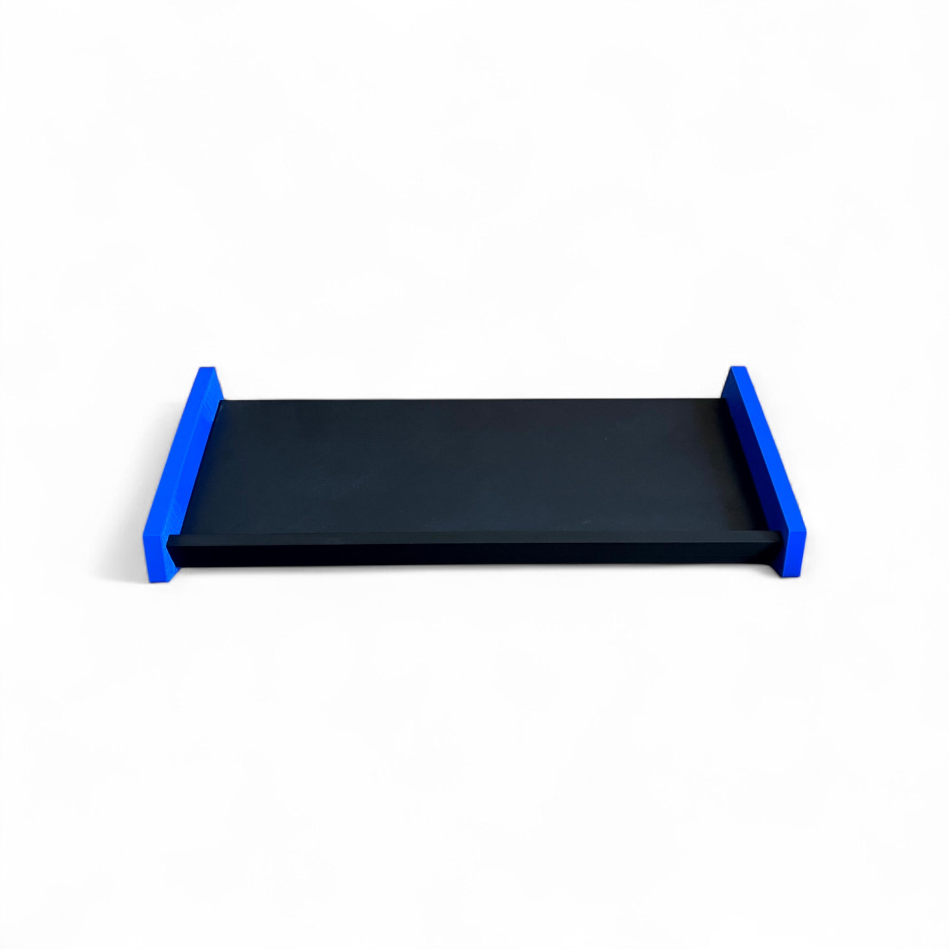 3D printed Desktop Pedalboard 400mm x 150mm 30 Degree Guitar Pedal & Synth Stand stand by Cold Earth Industries, shown from in front, in black with blue sides, on a white background – custom desktop stands.