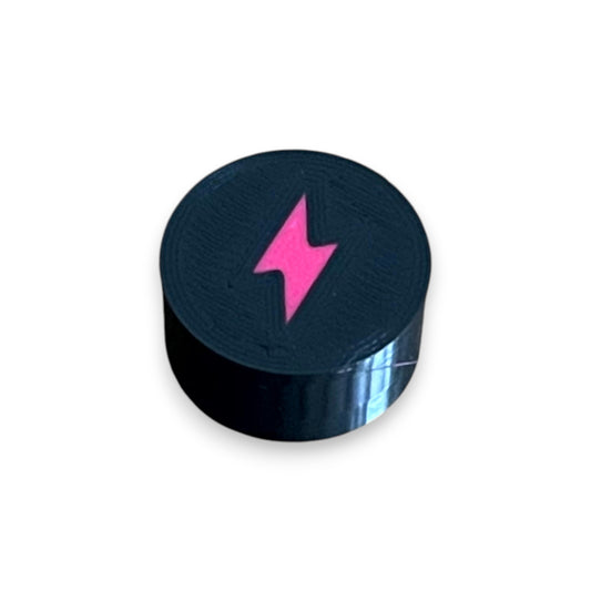 Electric Mistress Guitar Pedal Footswitch Topper for 8.5mm / 10mm / 11mm Foot Switch. 3D printed Electric Design by Cold Earth Industries, shown in black with a magenta bolt icon, on a white background.