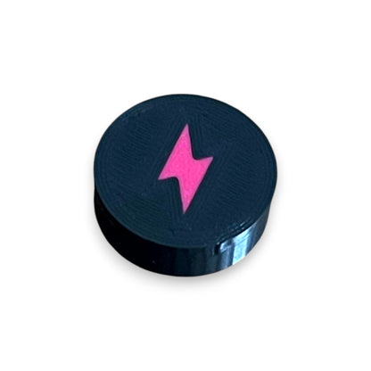 Low Profile Electric Mistress Guitar Pedal Footswitch Topper for 8.5mm / 10mm / 11mm Foot Switch. 3D printed Electric Design by Cold Earth Industries, shown in black with a magenta bolt icon, on a white background.