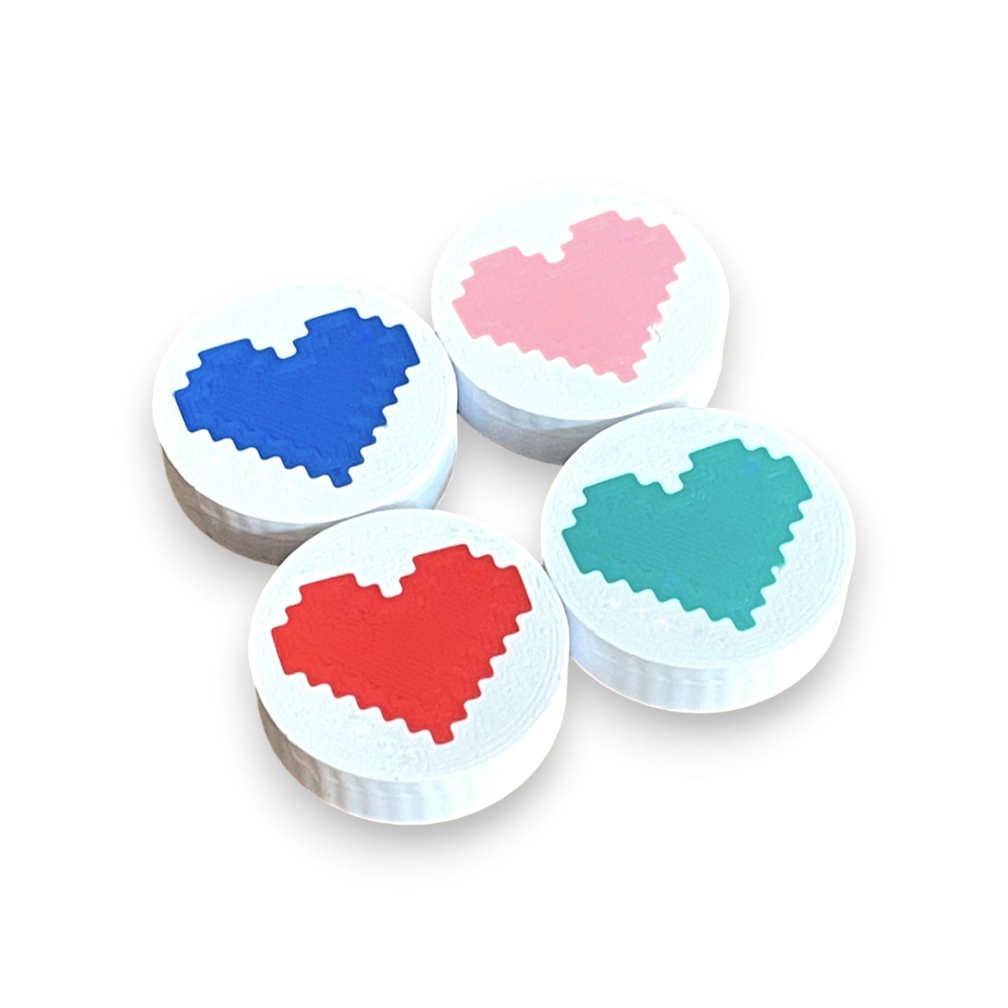 Low Profile Guitar Pedal Footswitch Topper for 8.5mm / 10mm / 11mm Foot Switch. 3D printed Heart Design on White Toppers with a Green, Red, Pink and Blue heart by Cold Earth Industries, shown on a white background.