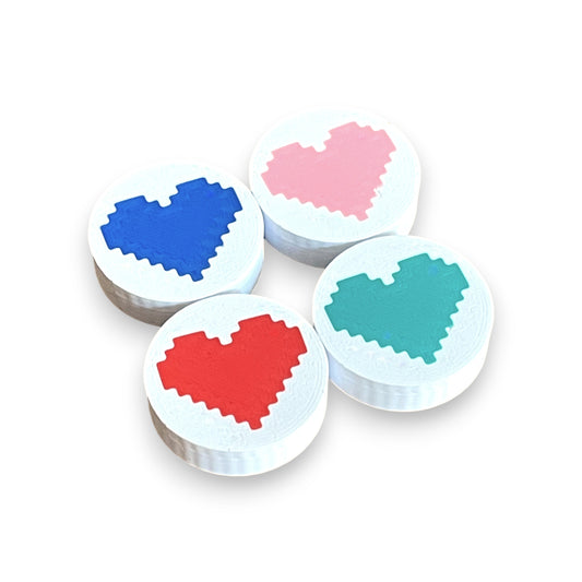 Low Profile Guitar Pedal Footswitch Topper for 8.5mm / 10mm / 11mm Foot Switch. 3D printed Heart Design on White Toppers with a Green, Red, Pink and Blue heart by Cold Earth Industries, shown on a white background.