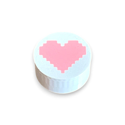 Guitar Pedal Footswitch Topper for 8.5mm / 10mm / 11mm Foot Switch. 3D printed Heart Design on a White Topper with a Pink heart by Cold Earth Industries, shown on a white background.