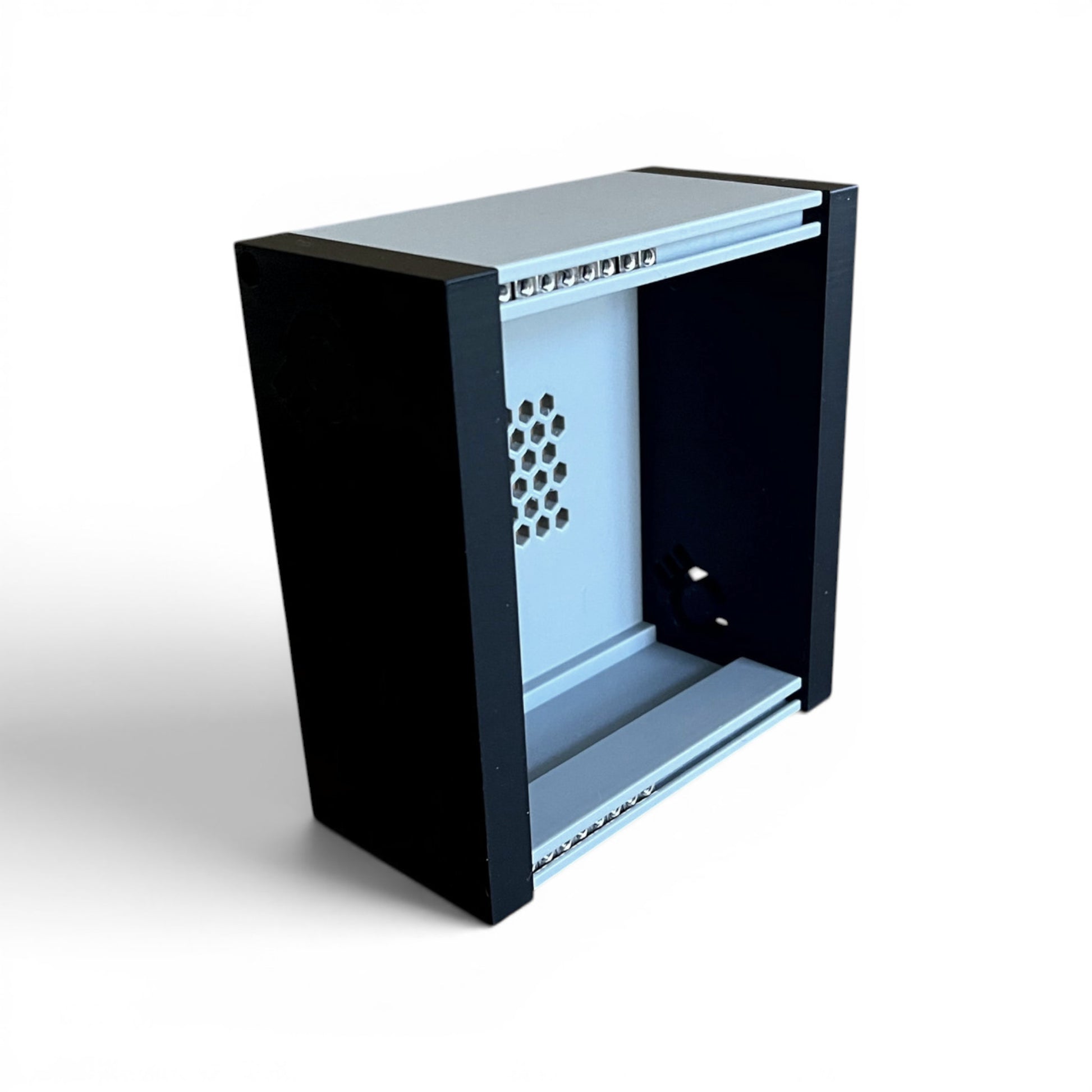 3D printed 20HP 3U Eurorack modular synthesizer case by Cold Earth Industries, shown, front angle view stood up, with grey body and black side panels on a white background – custom desktop skiff enclosure.