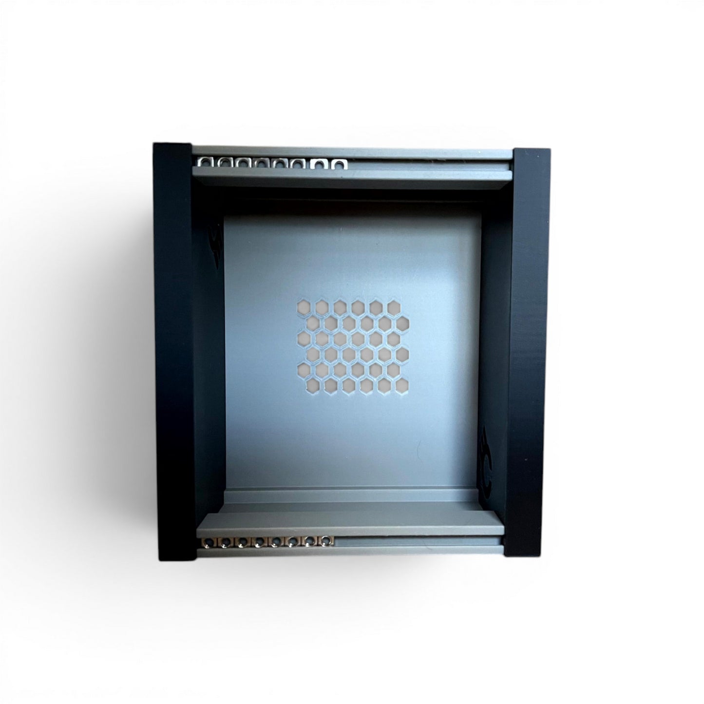 3D printed 20HP 3U Eurorack modular synthesizer case by Cold Earth Industries, shown, front view stood up, with grey body and black side panels on a white background – custom desktop skiff enclosure.