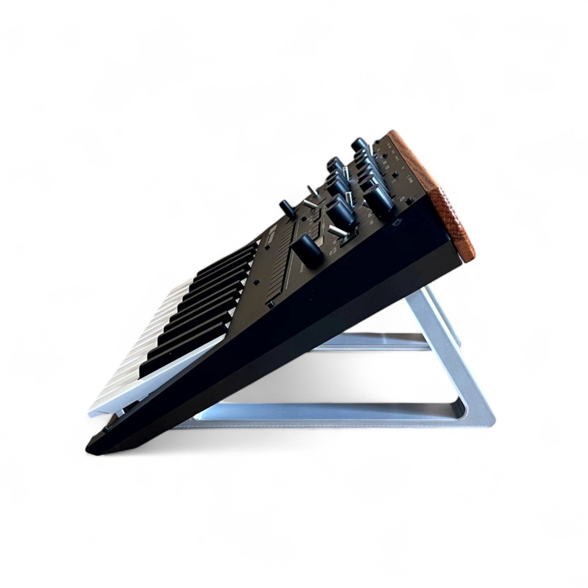3D printed Korg Monologue Synth 30 degree stand by Cold Earth Industries, shown side view in white on a white background holding a Korg Monologue