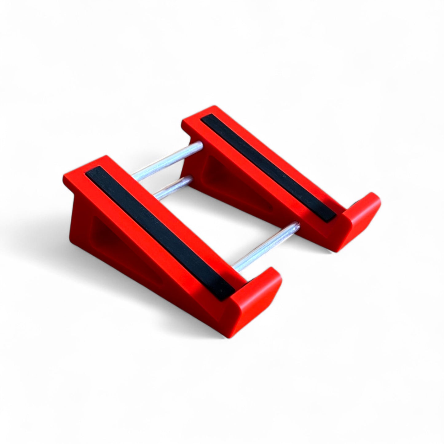 A 3D printed 20 degree red guitar pedal stand with rubber strips and recessed rubber feet, designed for the Line 6 HX Stomp Amp and Effects Processor.