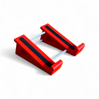 A 3D printed 20 degree red guitar pedal stand with rubber strips and recessed rubber feet, designed for the Line 6 HX Stomp Amp and Effects Processor.