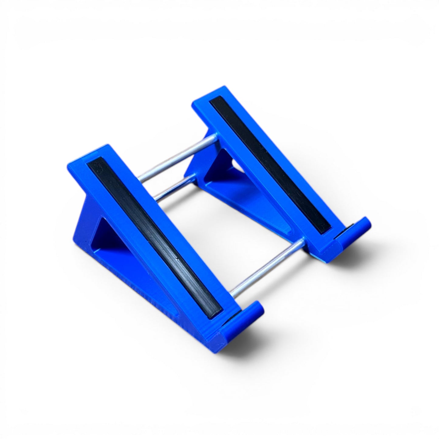 A 3D printed 30 degree blue guitar pedal stand with rubber strips and recessed rubber feet, designed for the Line 6 HX Stomp Amp and Effects Processor.