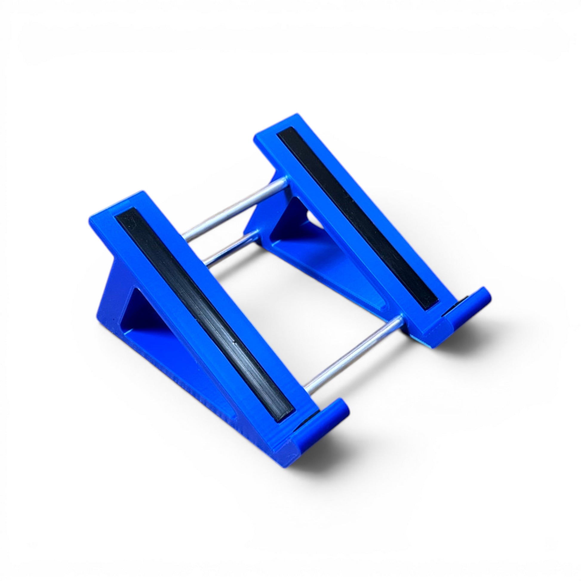 A 3D printed 30 degree blue guitar pedal stand with rubber strips and recessed rubber feet, designed for the Line 6 HX Stomp Amp and Effects Processor.