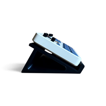 3D printed M-Vave FM-1 Synth 30 degree stand by Cold Earth Industries, shown side view, in black, on a white background holding an M-Vave FM-1 Synthesizer.