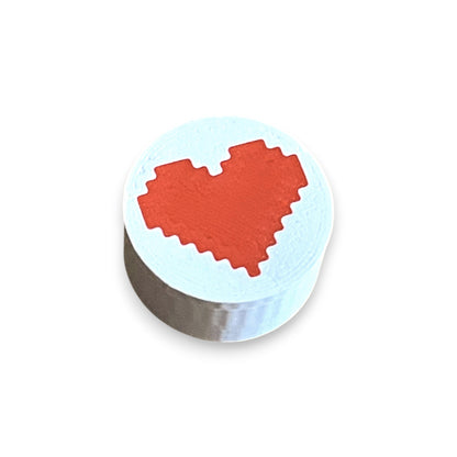 Guitar Pedal Footswitch Topper for 8.5mm / 10mm / 11mm Foot Switch. 3D printed Red Heart Design by Cold Earth Industries, shown on a guitar pedal, on a white background.