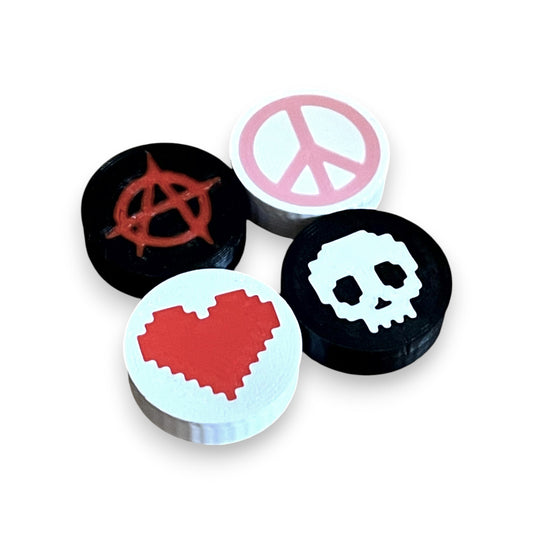 Low Profile Guitar Pedal Footswitch Topper for 8.5mm / 10mm / 11mm Foot Switch. 3D printed Mixed Set - Heart, Peace, Skull, Anarchy Design by Cold Earth Industries, shown on a white background.