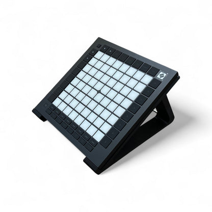 3D printed Novation Launchpad Pro MK3 Controllers 30 degree stand by Cold Earth Industries, shown in black on a white background holding a Novation Launcpad Pro MK3