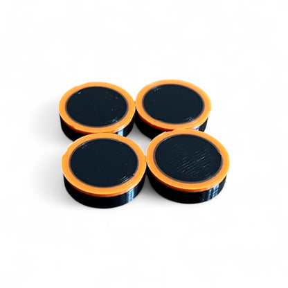 Set of 4 Guitar Pedal Footswitch Topper Low Profile for 11MM Foot Switch. 3D printed Black Base and Orange Ring Design by Cold Earth Industries, shown on a white background.