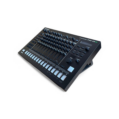 3D printed Roland TR-8S Rhythm Performer Drum Machine 30 degree stand by Cold Earth Industries, shown in black on a white background holding a Roland TR-8S